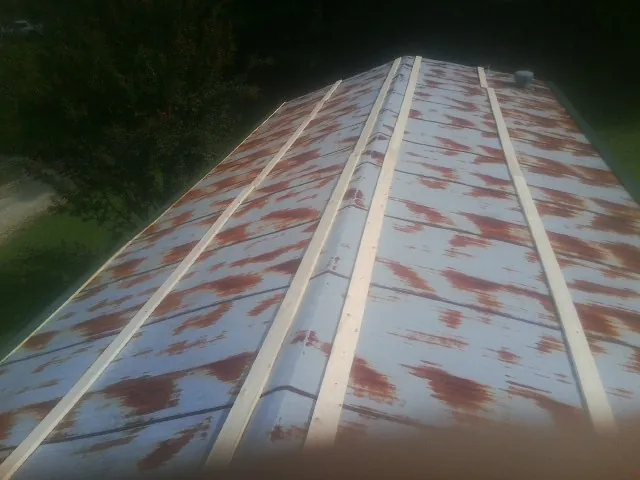 Rusted metal roof panels with new wood purlins before replacement — Storm Damage Roof Repair in Putnam by Roofing Brothers