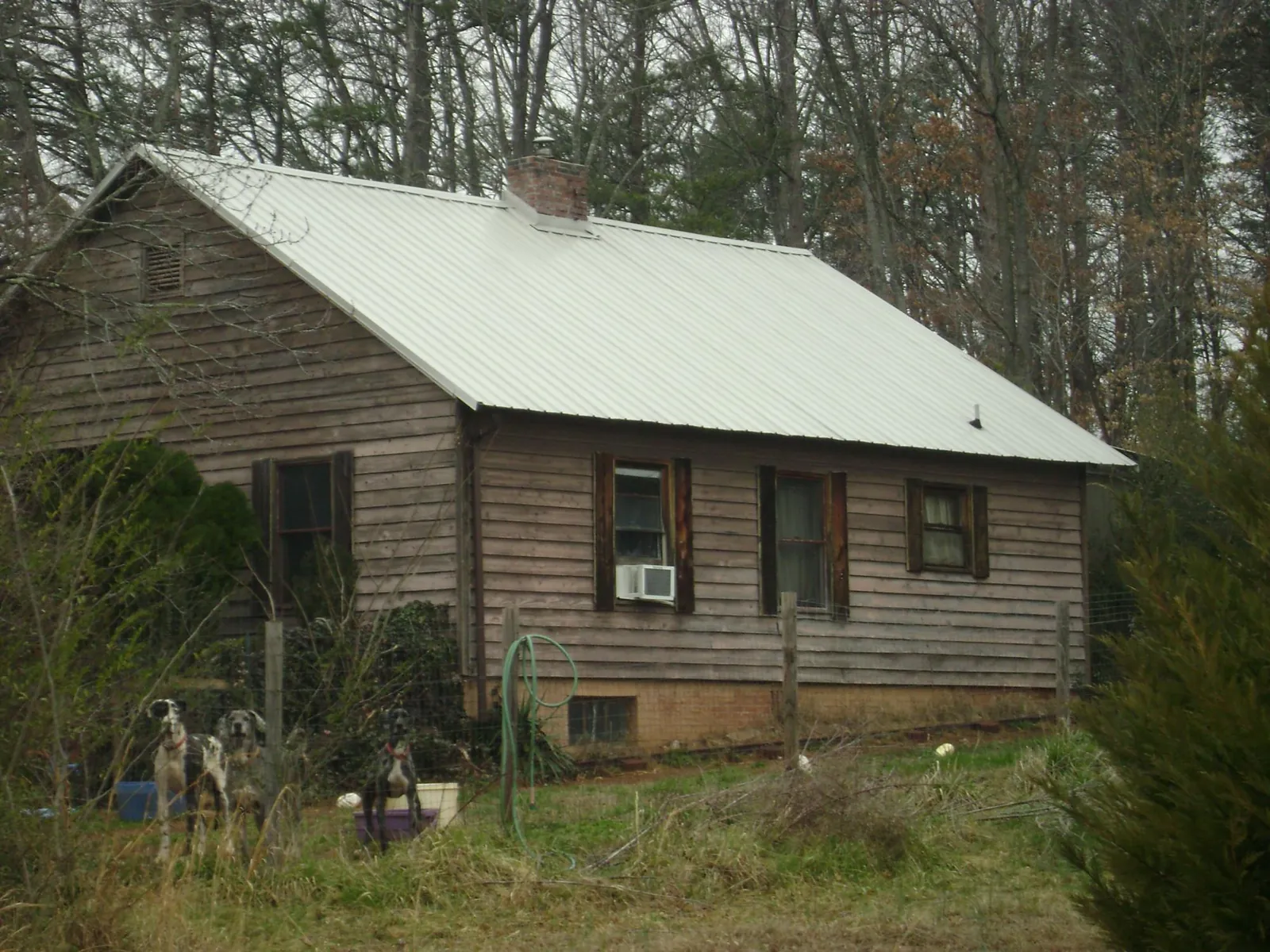 White metal roof on an old wood sided farmhouse, from a Metal Roof Installation job in Putnam